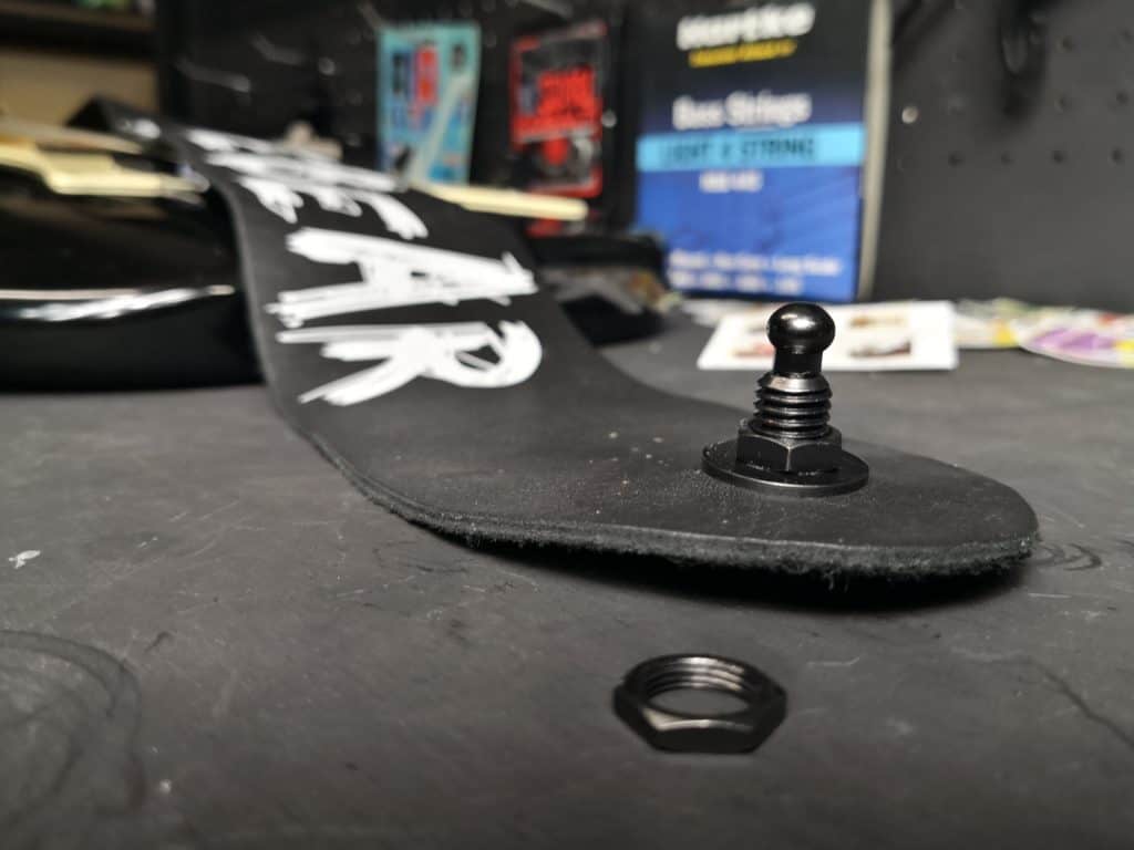PLB guitar strap with one nut in place